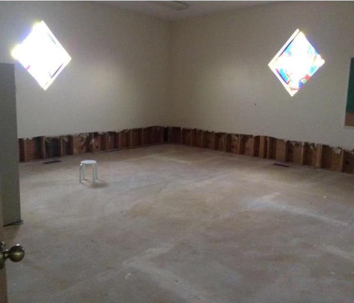 Youth room in church has had all carpet removed as well as the bottom 12 inches of drywall.  Room is empty.