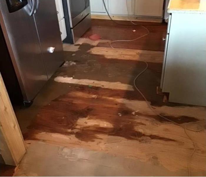 Water leaked from refrigerator, soaking the kitchen floors. 
